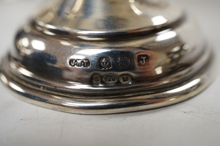 A pair of George V small silver two handled trophy cups by J W Tiptaft & Son Ltd, Birmingham, 1933, height 10cm, one with plinth, together with a George V silver ashtray with inset coin base.